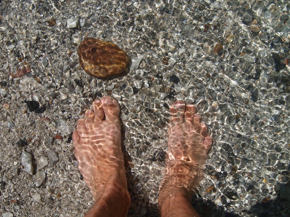 feet in the crystal clear water