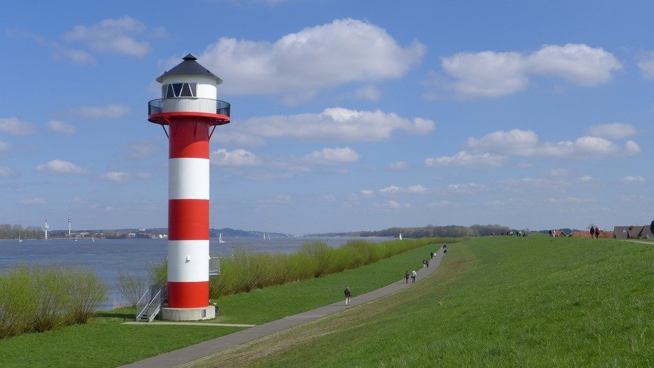 striped lighthouse on the banks of the river Elb