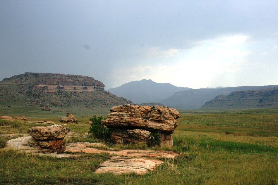 landscape of large rocks on the green meadow