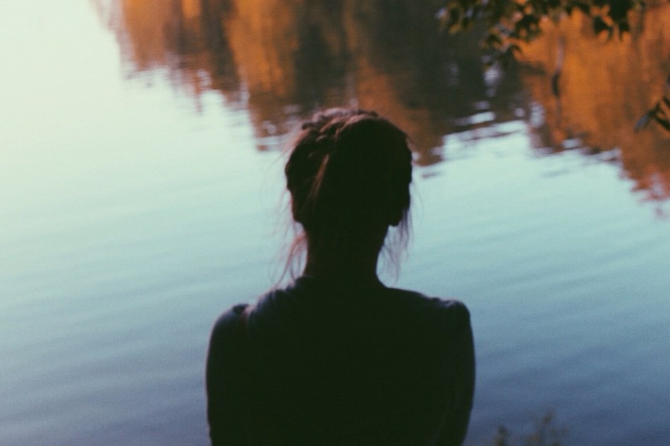 silhouette of a girl near the water