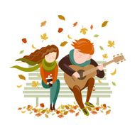 Boy plays guitar for a girl in the autumn park