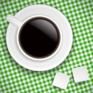 Cup of coffee on green tablecloth