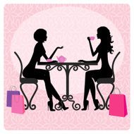 Silhouette of two beautiful girls talking in cafe
