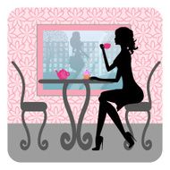 Silhouette of beautiful girl sits in cafe