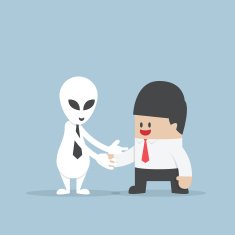 Businessman shaking hands with Alien