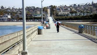 Walking people on a pier