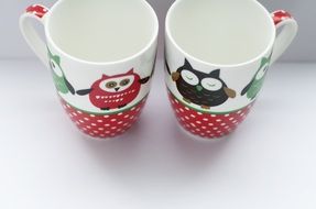 two cups painted with cartoon owls