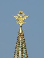 double headed imperial eagle on spire of kremlin tower at sky, russia, moscow