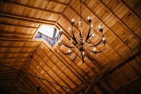 chandelier on an wood ceiling