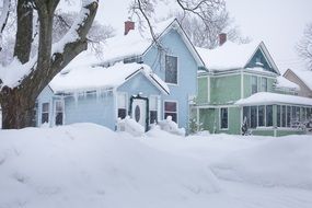 Snow on root houses winter season