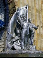 working people with flag, sculpture at facade of National Economy Achievement Exhibition, russia, moscow