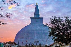 sunset sky over a large temple in asia
