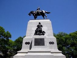 Beautiful monument with a horse among the plants