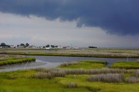 river in the village and dark clouds