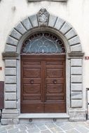 Wooden front door with stone arch