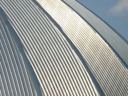 domed roof made of aluminum and blue sky with white clouds at background