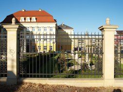 old buildings behind metal fencing