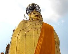 golden buddha statue near a temple in bangkok