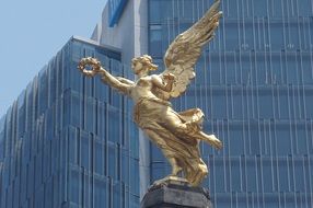 golden statue on the roof of a building