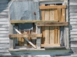 boarded up house wall