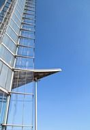 steel and glass corner of skyscraper at sky