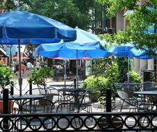 sidewalk cafe with blue umbrellas