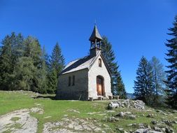 chapel on beautiful mountains with the plants on a sunny day