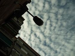 street lamp against cloudy sky