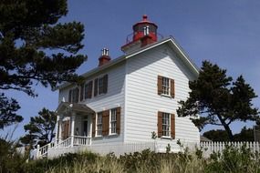 building with a lighthouse on the coastline