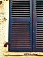window with blue shutters closeup