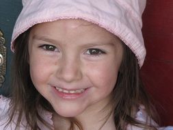 Cute young girl with the pink hat