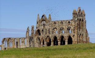 Gothic building on meadow in England