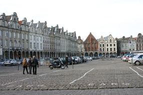 people on the road near buildings in the city