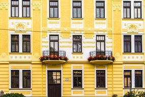 yellow building facade with balconies