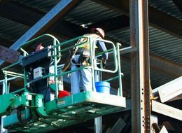 Worker on the metal construction at the factory