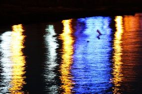 reflections of evening city on water