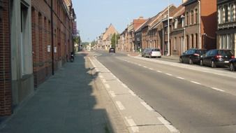 street in belgium with parked cars on the road