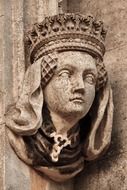 female face, sculpture, detail of a historic facade