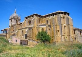 landscape of old stone church on a green hill