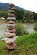 balance art, stone tower on riverside at summer