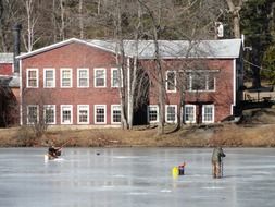 Ice fishing on a frozen river in Massachusetts