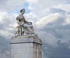 statue under a cloudy sky in paris, pont du carrousel