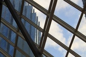 blue clouds through a modern glass roof