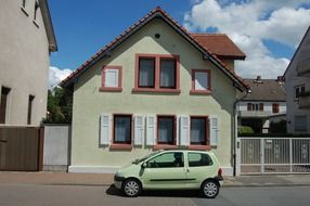 green small car on a street