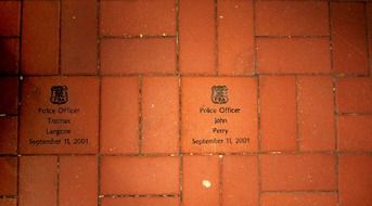 tile on the ground with the names of the cops