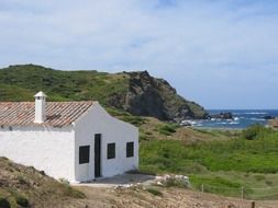 white building on a rocky coast