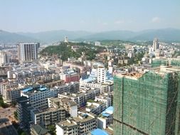 roof view of modern cityscape at green mountains, china, guanguian