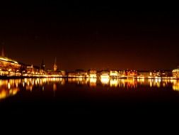 landscape of illuminated waterfront of city at night