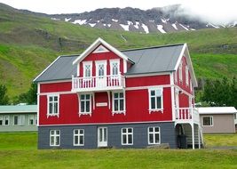 house on a green meadow in iceland
