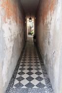hallway with black and white tiles on the floor